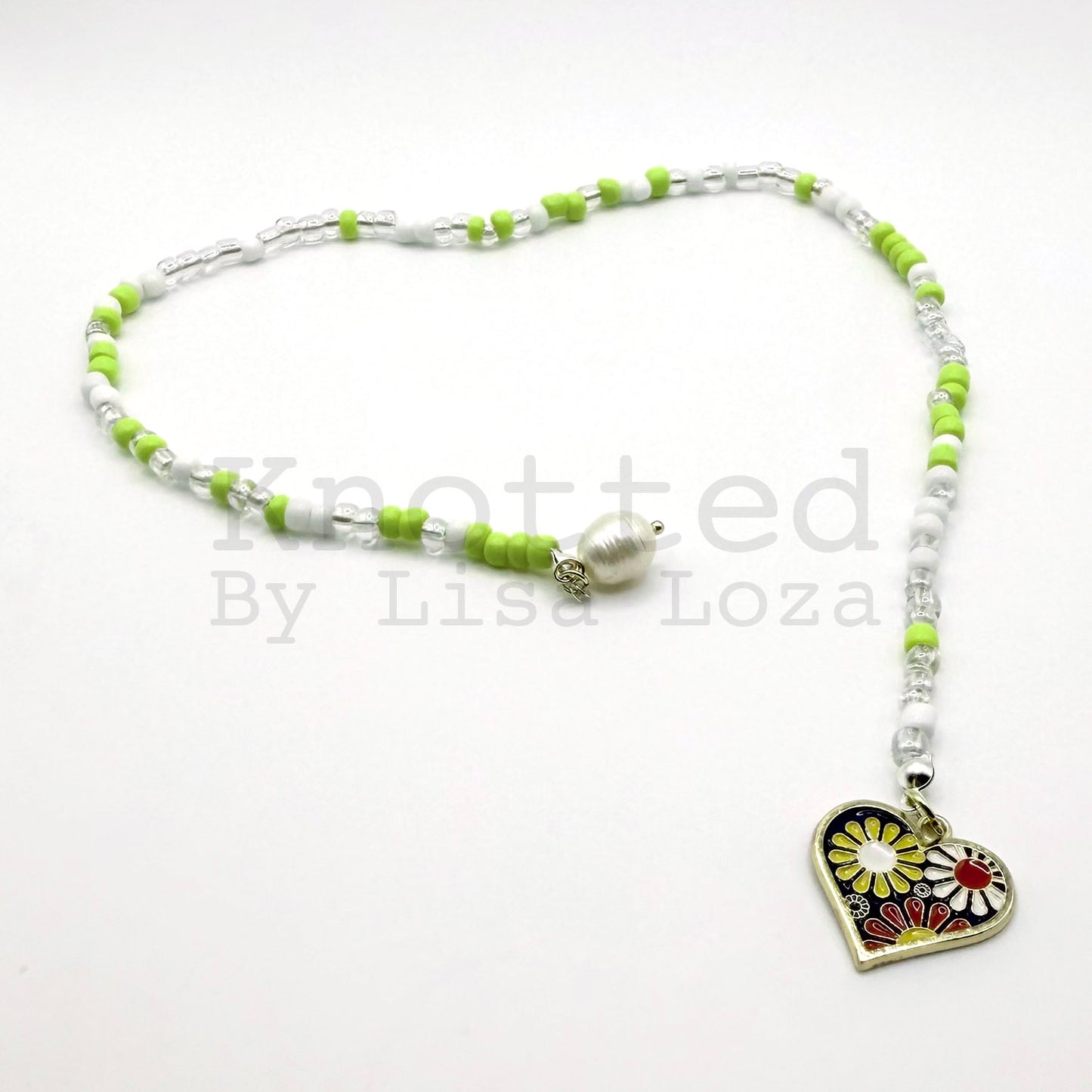 Green and white beaded bookmark with flower, heart, and pearl charms