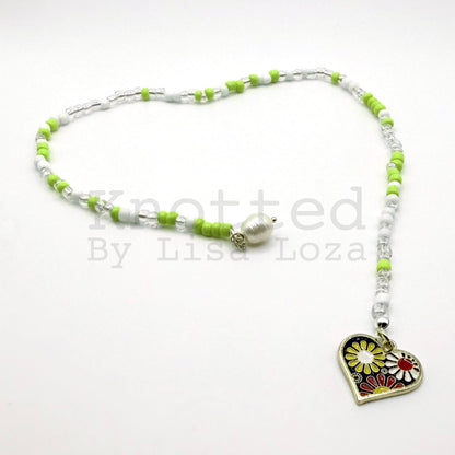 Green and white beaded bookmark with flower, heart, and pearl charms