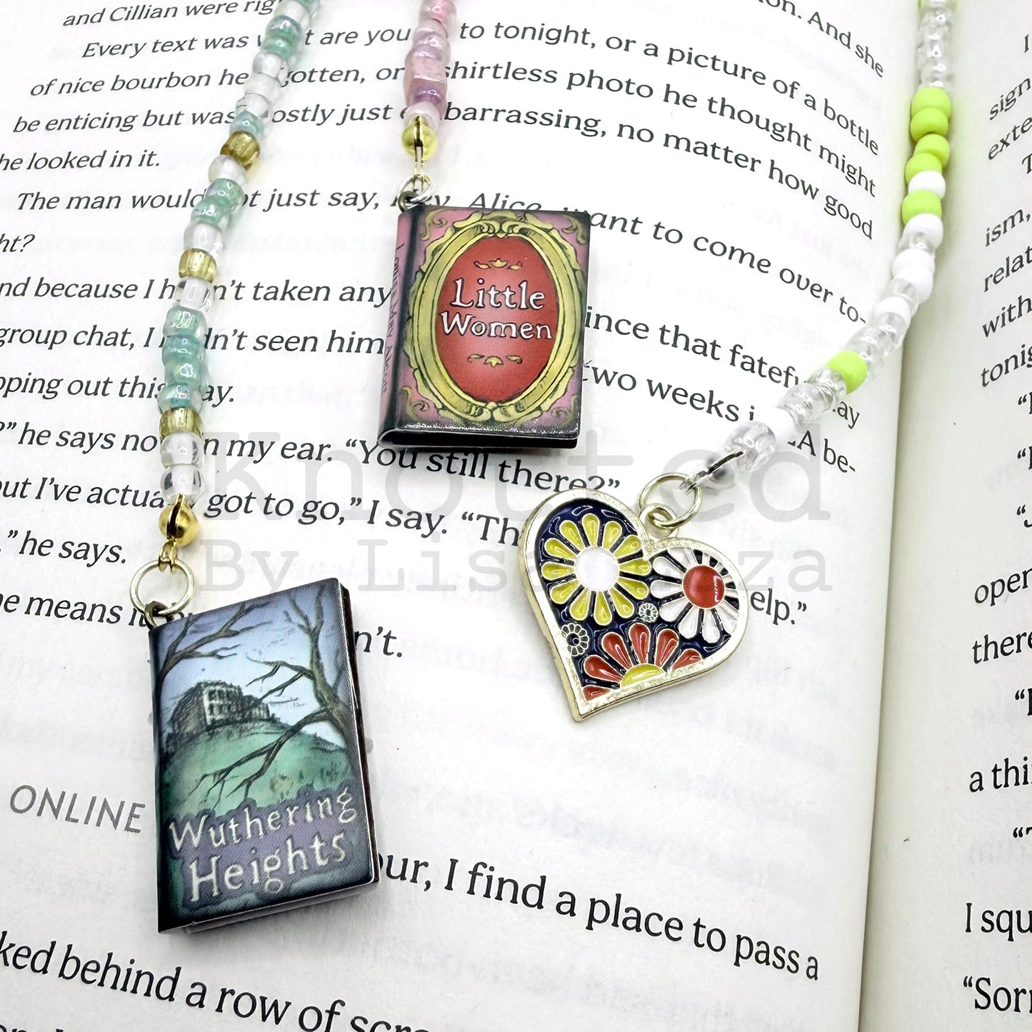 Three beaded bookmarks laying on top of open book page