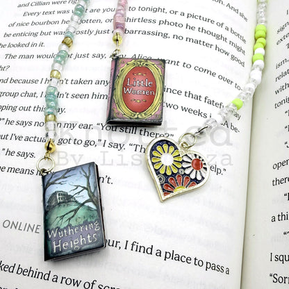 Three beaded bookmarks laying on top of open book page
