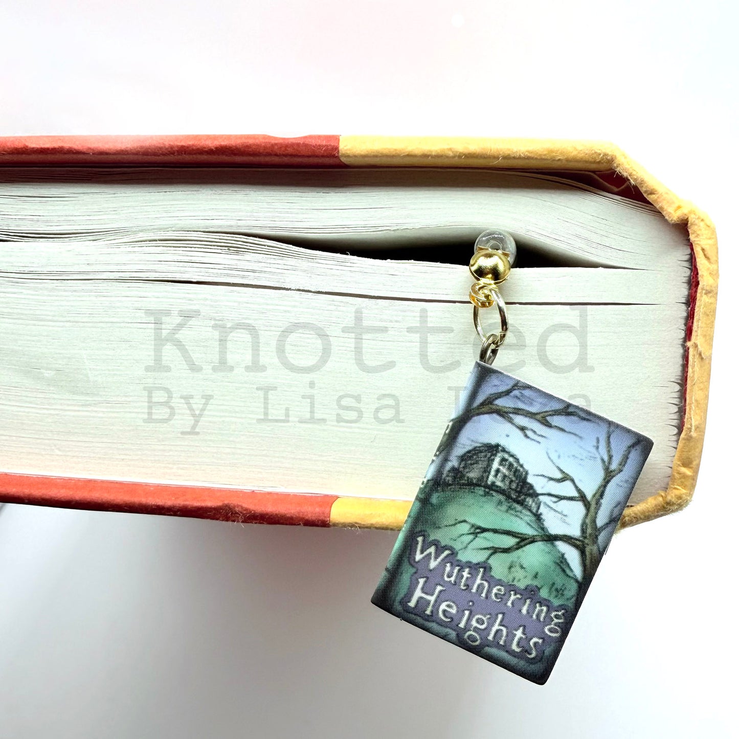Beaded bookmark with small book hanging from side of closed book