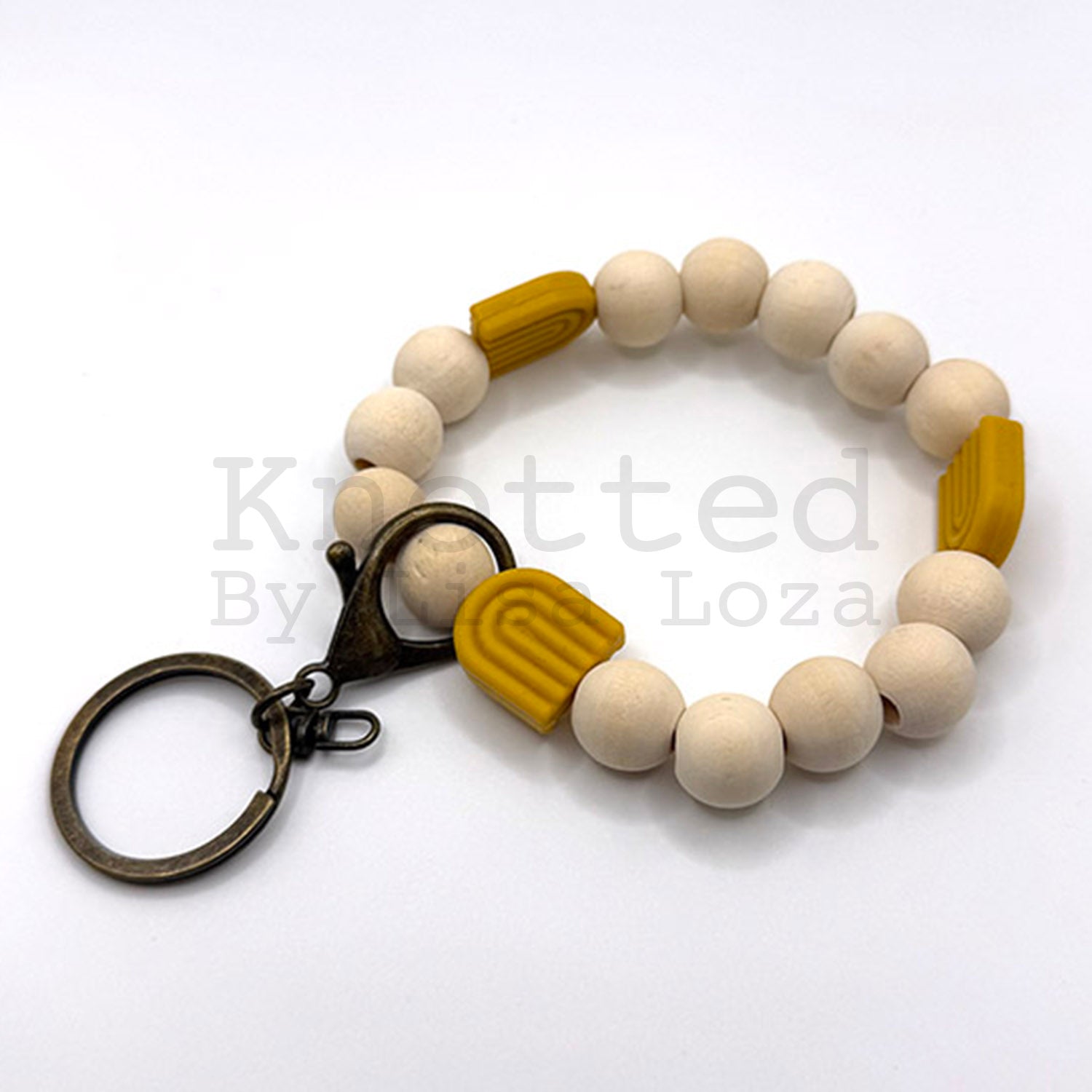 Gold wood bead keychain bracelet with silicone rainbow by Knotted by Lisa Loza