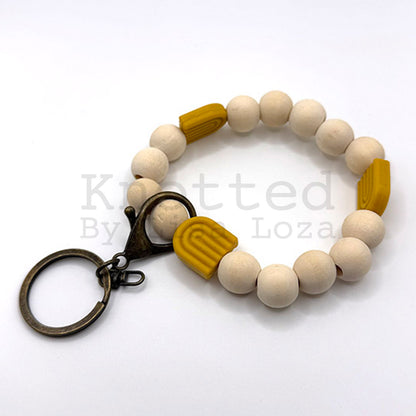 Gold wood bead keychain bracelet with silicone rainbow by Knotted by Lisa Loza