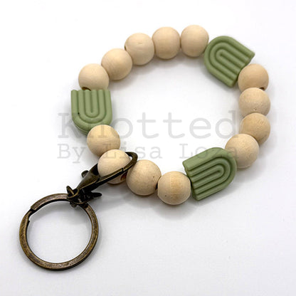 Green wood bead keychain bracelet with silicone rainbow by Knotted by Lisa Loza