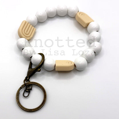 White wood bead keychain bracelet with cream silicone rainbow charm